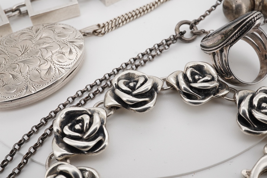 A Danish Hans Hansen 925 square link bracelet, 19.2cm, together with an modern engraved silver oval locket on a 925 chain, a 925 ring, a 925 flower head link bracelet and a modern heart shaped scent flask on chain. Condi